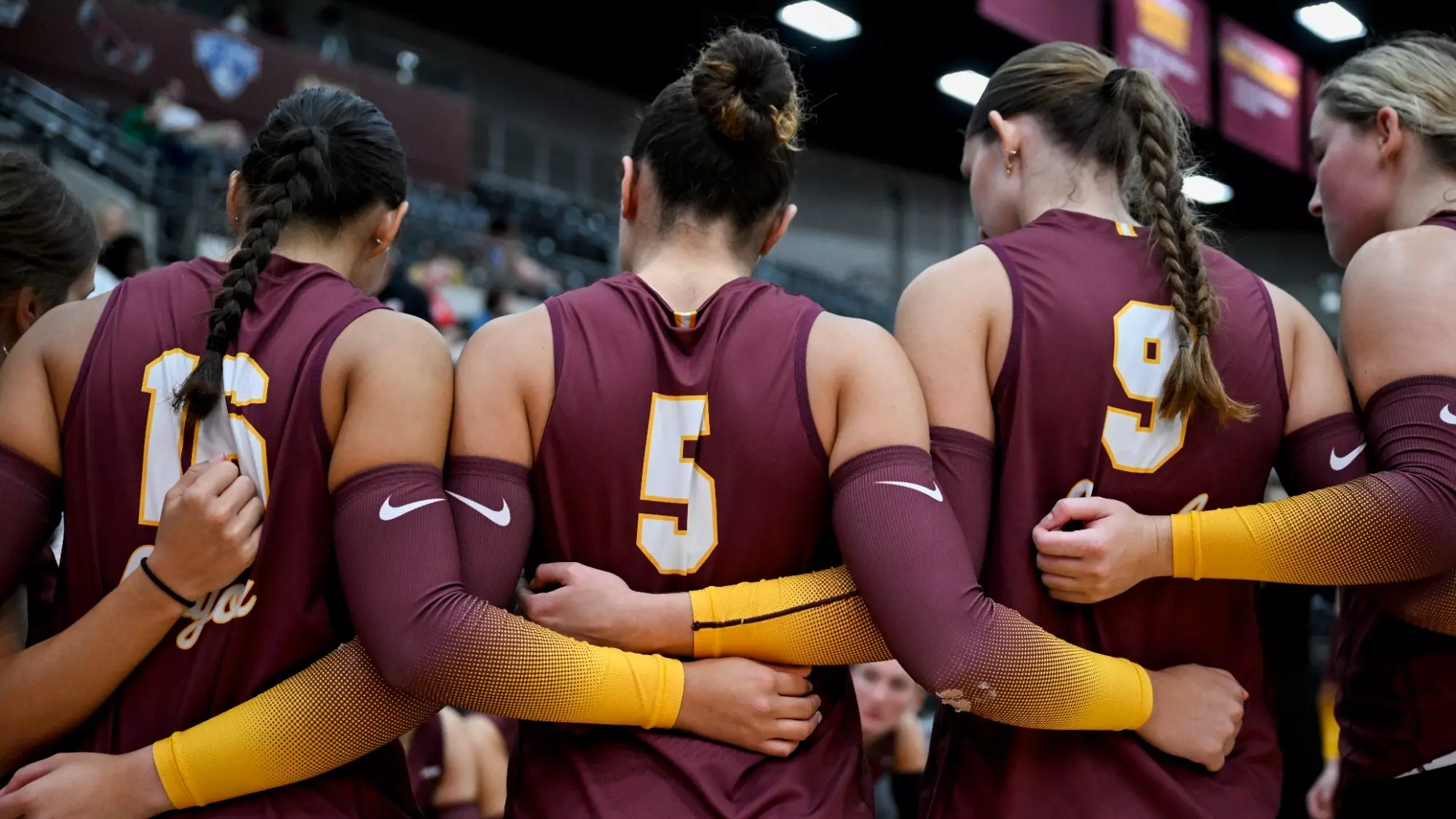 Loyola Chicago volleyball team huddled together
